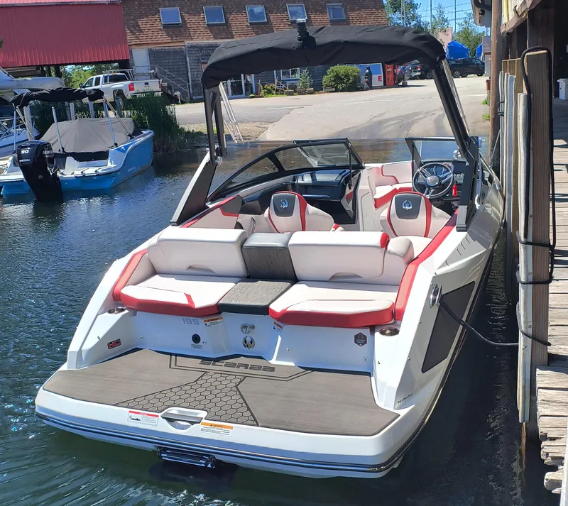Slide: The Image of 2023 Scarab 195 ID boat docked, featuring sleek design and comfortable seating. - 6
