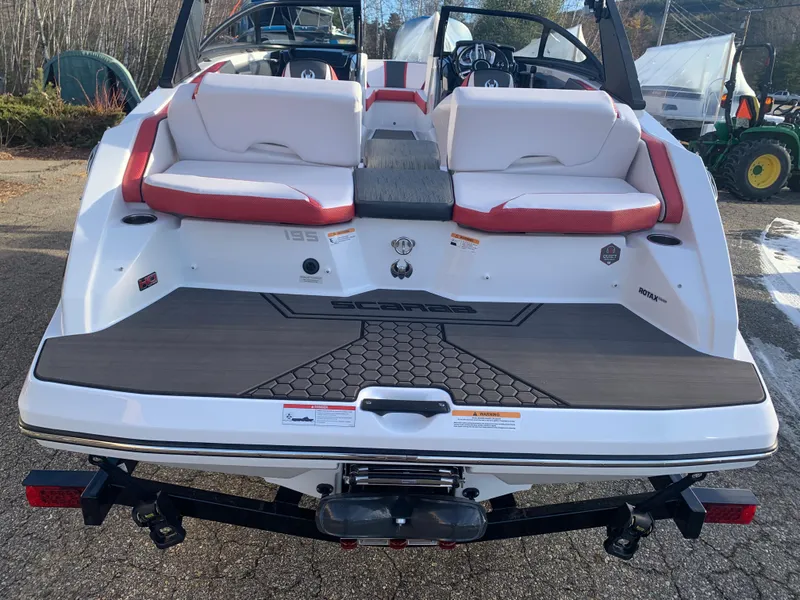 Slide: The Image of 2023 Scarab 195 ID boat, rear view, white and red seating, on a trailer. - 8