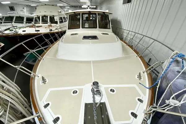 Slide: The Image of 2011 Grand Banks 46 Eastbay SX cruising on open water, creating a dynamic wake. - 10