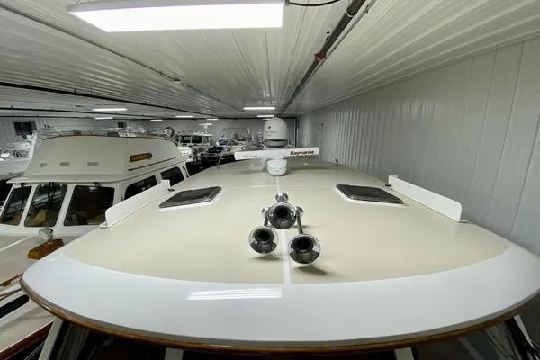 Slide: The Image of 2011 Grand Banks 46 Eastbay SX yacht cruising on open water under a blue sky. - 13