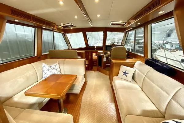 Slide: The Image of 2011 Grand Banks 46 Eastbay SX yacht cruising on open water under a partly cloudy sky. - 14