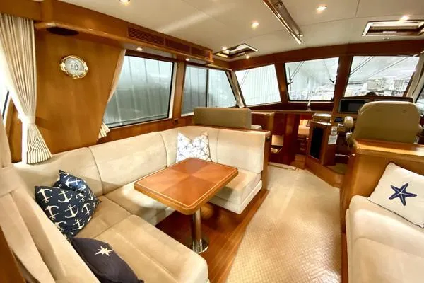 Slide: The Image of 2011 Grand Banks 46 Eastbay SX cruising on open water under a clear sky. - 15