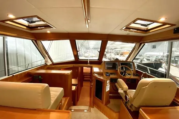 Slide: The Image of 2011 Grand Banks 46 Eastbay SX yacht cruising on open water under a cloudy sky. - 17