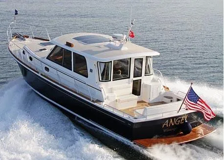 Slide: The Image of 2011 Grand Banks 46 Eastbay SX yacht cruising on open water under a clear sky. - 2