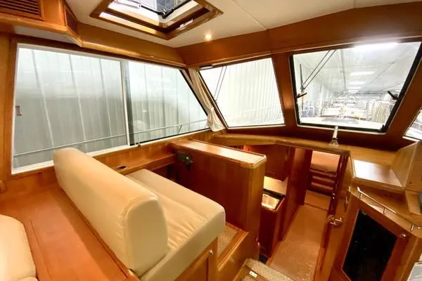 Slide: The Image of 2011 Grand Banks 46 Eastbay SX yacht cruising on open water under a partly cloudy sky. - 20