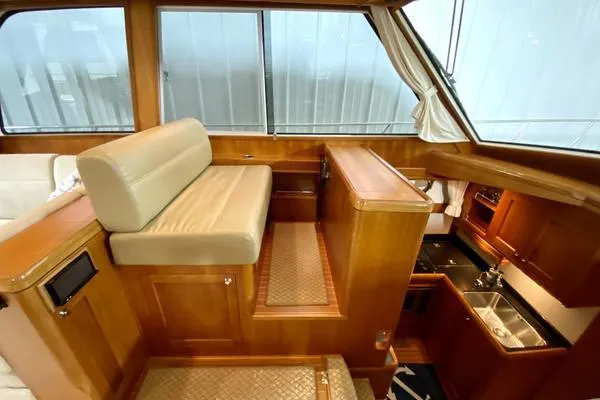 Slide: The Image of 2011 Grand Banks 46 Eastbay SX yacht cruising on open water under a partly cloudy sky. - 21