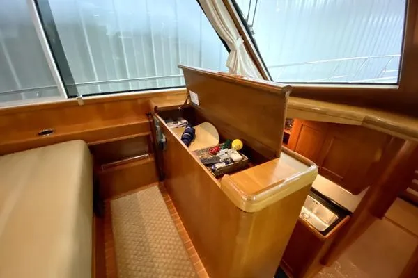 Slide: The Image of 2011 Grand Banks 46 Eastbay SX yacht cruising on open water under a partly cloudy sky. - 22