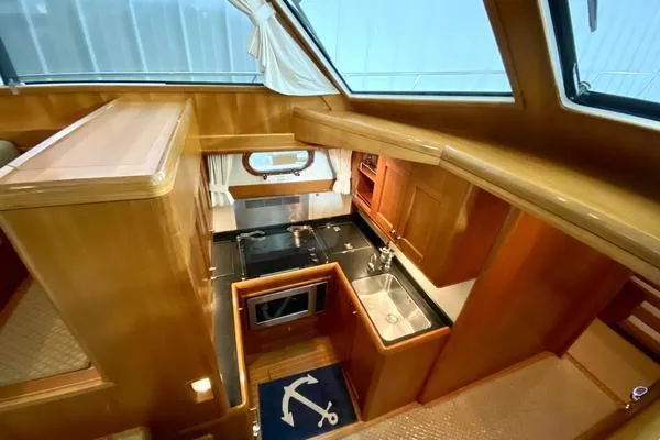 Slide: The Image of 2011 Grand Banks 46 Eastbay SX cruising on open water under a clear sky. - 24