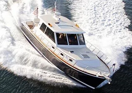 Slide: The Image of 2011 Grand Banks 46 Eastbay SX yacht cruising on open water under a clear sky. - 3