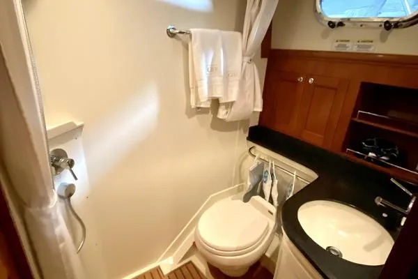 Slide: The Image of 2011 Grand Banks 46 Eastbay SX yacht deck with American flag, ocean view. - 31