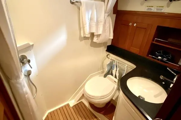 Slide: The Image of Grand Banks 46 Eastbay SX 2011 yacht with American flag, white seating, and ocean view. - 32