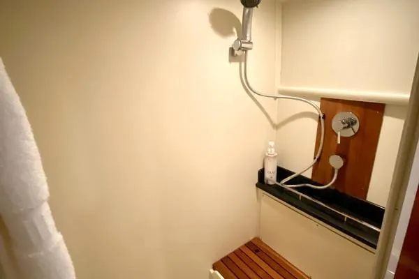 Slide: The Image of 2011 Grand Banks 46 Eastbay SX with dinghy and American flag on open water. - 33