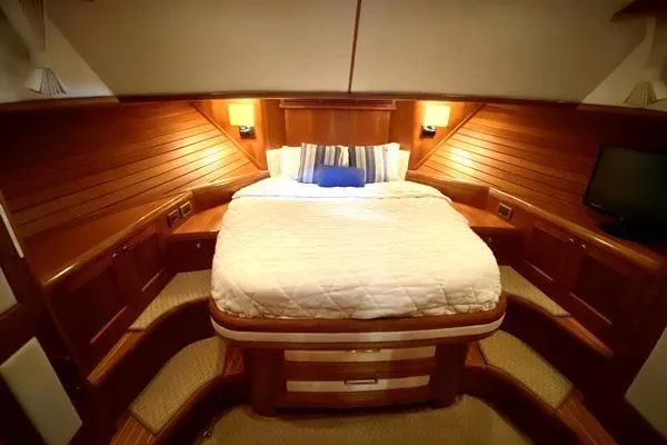 Slide: The Image of 2011 Grand Banks 46 Eastbay SX yacht with radar, cruising near shoreline. - 34