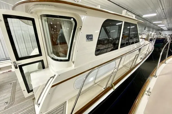 Slide: The Image of 2011 Grand Banks 46 Eastbay SX yacht cruising on open water under a clear sky. - 4