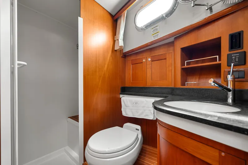 Slide: The Image of Luxurious 2011 Grand Banks 46 Eastbay SX yacht bathroom with wood cabinetry and modern fixtures. - 53
