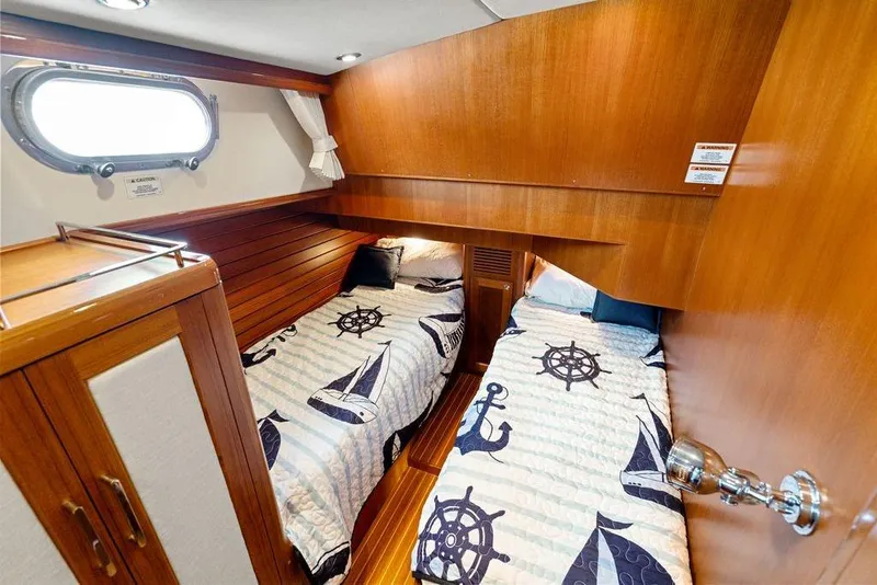 Slide: The Image of Cabin interior of 2011 Grand Banks 46 Eastbay SX with twin beds and nautical decor. - 54