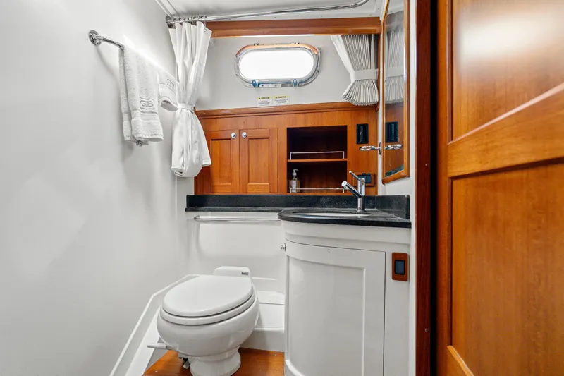 Slide: The Image of Luxurious bathroom in 2011 Grand Banks 46 Eastbay SX yacht with wood accents and modern fixtures. - 56