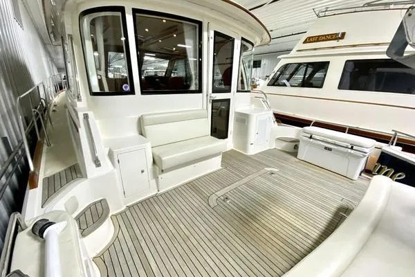 Slide: The Image of 2011 Grand Banks 46 Eastbay SX yacht cruising on open water under blue skies. - 6