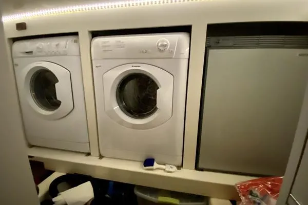 Slide: The Image of Laundry appliances inside a 2011 Grand Banks 46 Eastbay SX yacht. - 66