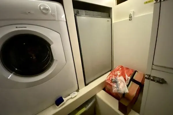 Slide: The Image of Laundry area on 2011 Grand Banks 46 Eastbay SX with washer and storage. - 67