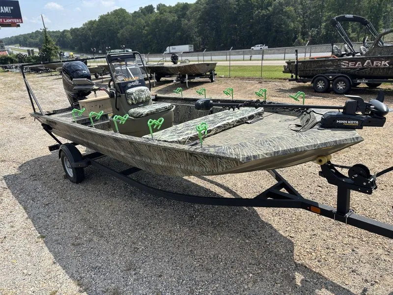 Slide: The Image of 2025 Tracker GRIZZLY® 1860 CC boat on trailer, camo design, outdoor setting. - 10