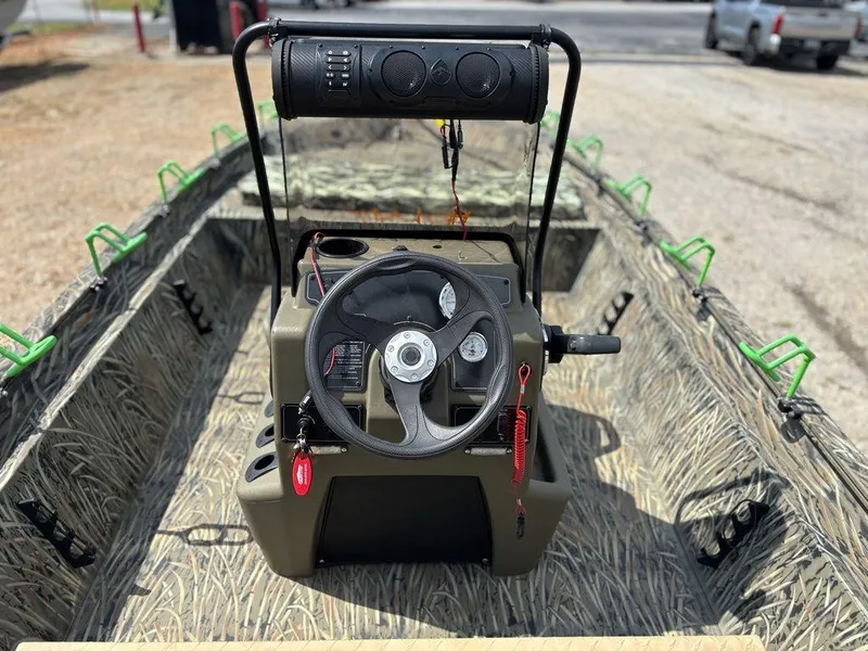 Slide: The Image of 2025 Tracker GRIZZLY® 1860 CC boat interior with steering wheel and control panel. - 14