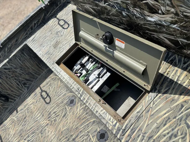 Slide: The Image of Open storage compartment on 2025 Tracker GRIZZLY® 1860 CC boat, showcasing interior details. - 18