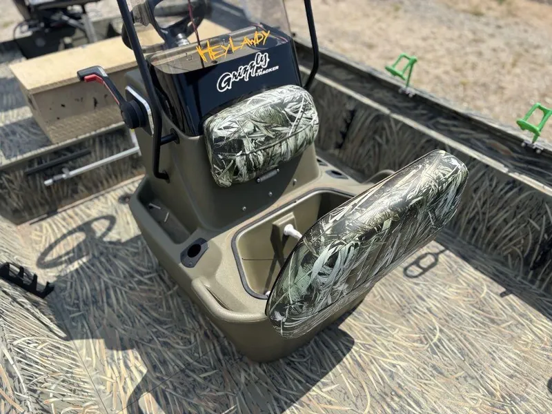 Slide: The Image of 2025 Tracker GRIZZLY® 1860 CC boat interior with camo seats and steering console. - 21