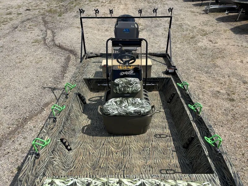 Slide: The Image of 2025 Tracker GRIZZLY® 1860 CC boat with camouflage interior and fishing rod holders. - 22