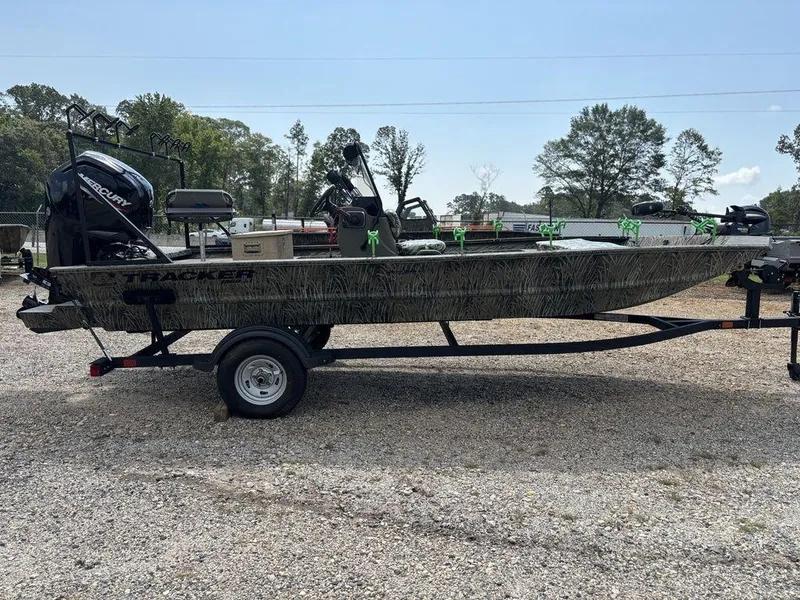 Slide: The Image of 2025 Tracker GRIZZLY® 1860 CC boat on trailer, parked outdoors. - 6