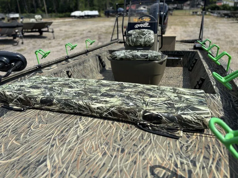 Slide: The Image of 2025 Tracker GRIZZLY® 1860 CC boat with camouflage seating and green rod holders. - 8