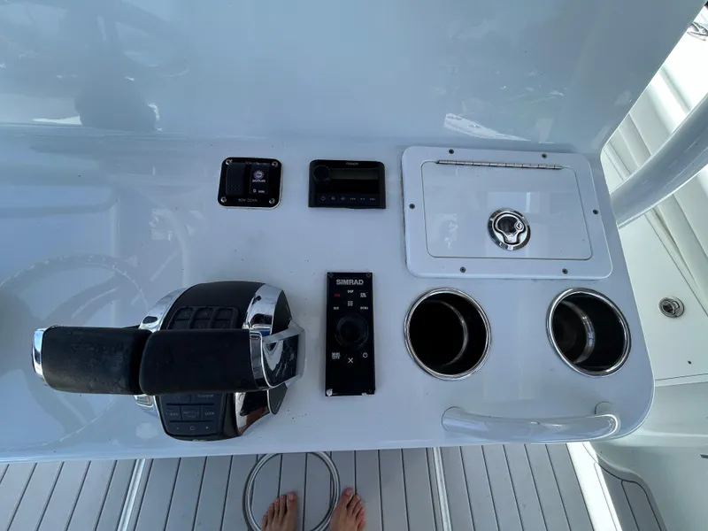 Slide: The Image of Control panel of a 2019 Yellowfin 36 Offshore boat with throttle and cup holders. - 11