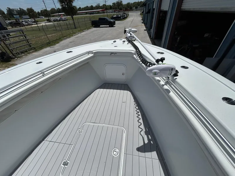 Slide: The Image of 2019 Yellowfin 36 Offshore boat deck with trolling motor, docked in a marina. - 13