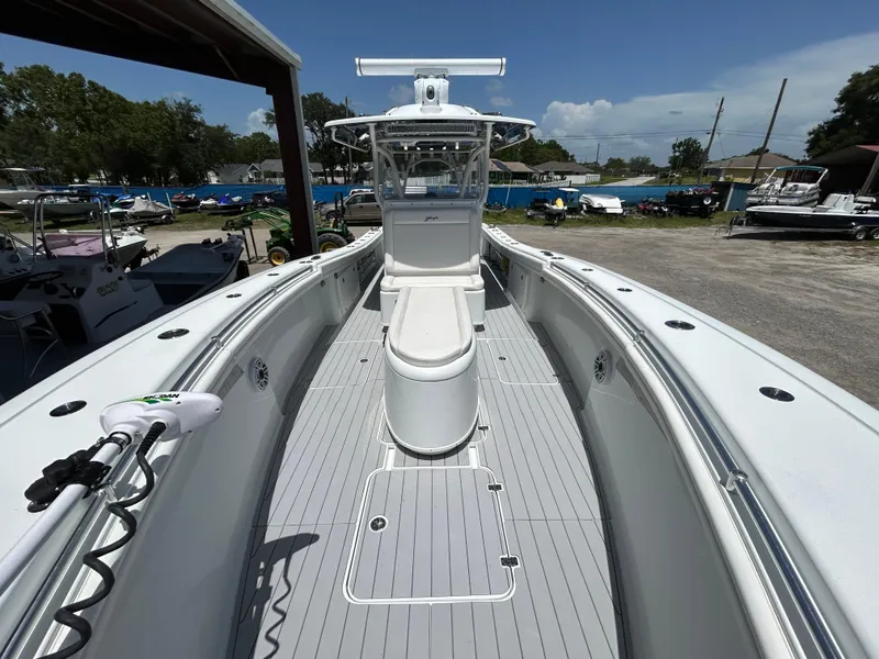 Slide: The Image of 2019 Yellowfin 36 Offshore boat, spacious deck, sleek design, parked outdoors under clear sky. - 16
