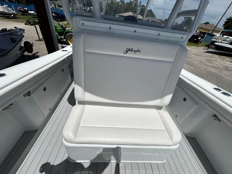 Slide: The Image of 2019 Yellowfin 36 Offshore boat interior with white seating and storage compartments. - 21