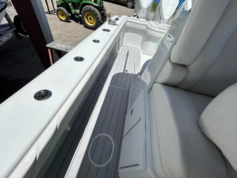 Slide: The Image of 2019 Yellowfin 36 Offshore boat interior with white seating and rod holders. - 23