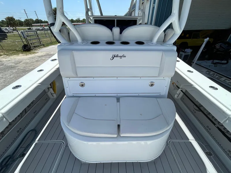 Slide: The Image of 2019 Yellowfin 36 Offshore boat interior with white seating and storage compartments. - 24