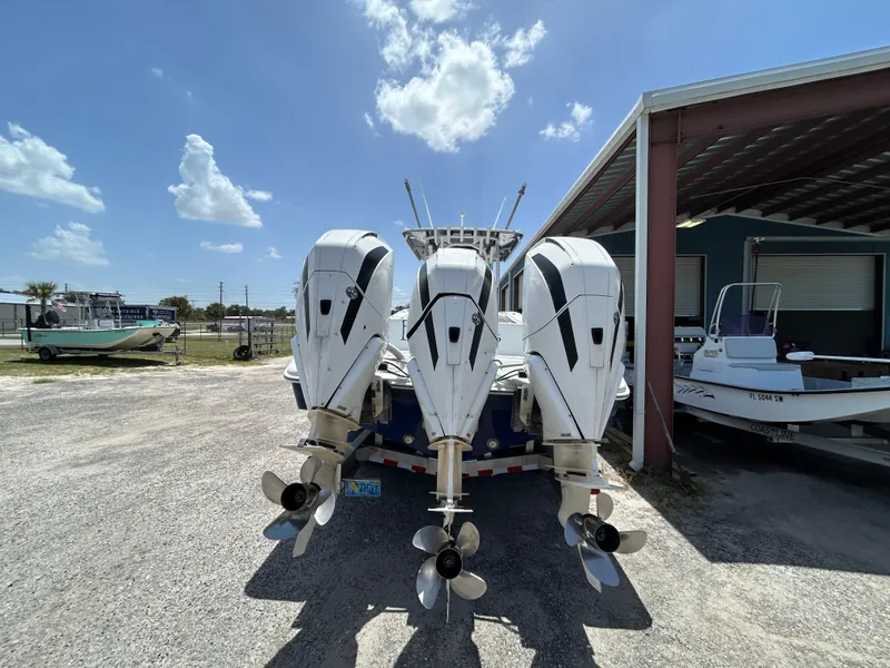 Slide: The Image of 2019 Yellowfin 36 Offshore boat with triple outboard engines in a sunny outdoor setting. - 4