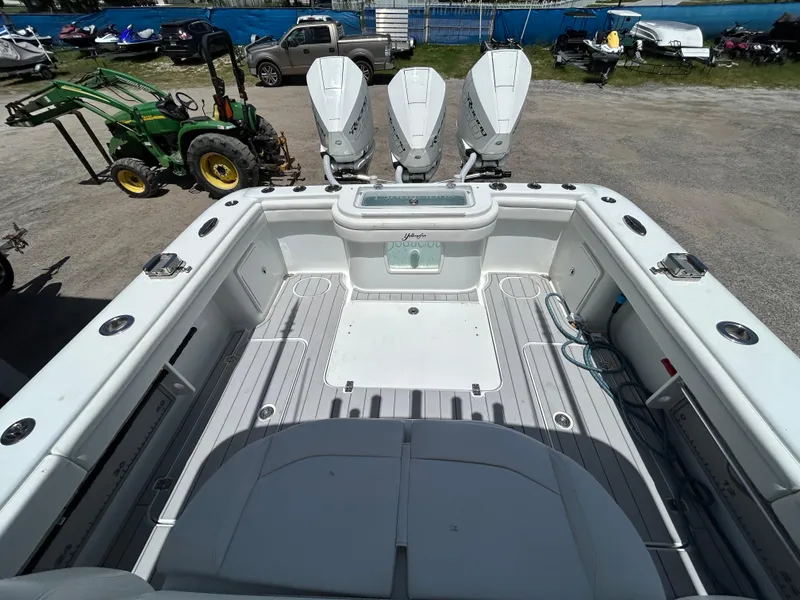 Slide: The Image of 2019 Yellowfin 36 Offshore boat with triple outboard engines, spacious deck, and fishing equipment. - 6
