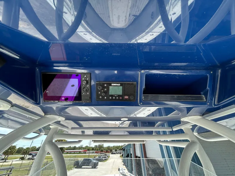 Slide: The Image of 2019 Yellowfin 36 Offshore boat console with navigation equipment and storage compartments. - 9