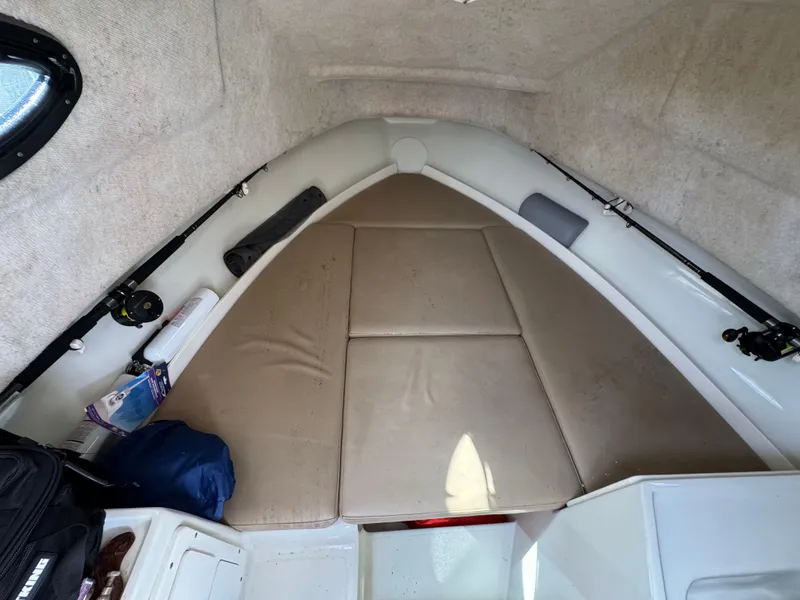 Slide: The Image of 2005 Hydra-Sports Lightning 230 WA cabin interior with beige cushions and fishing gear. - 10