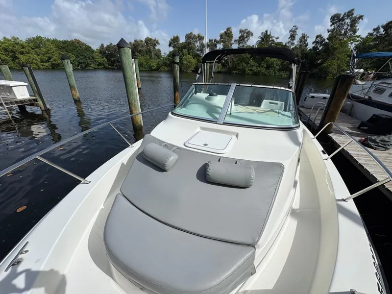 Slide: The Image of 2005 Hydra-Sports Lightning 230 WA boat docked by a serene waterfront. - 12