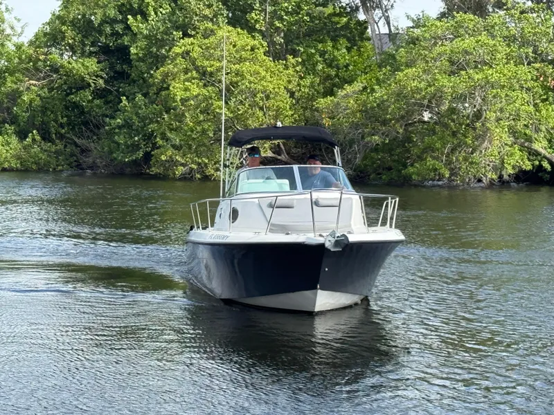 Slide: The Image of 2005 Hydra-Sports Lightning 230 WA boat cruising on a calm river with lush greenery. - 3