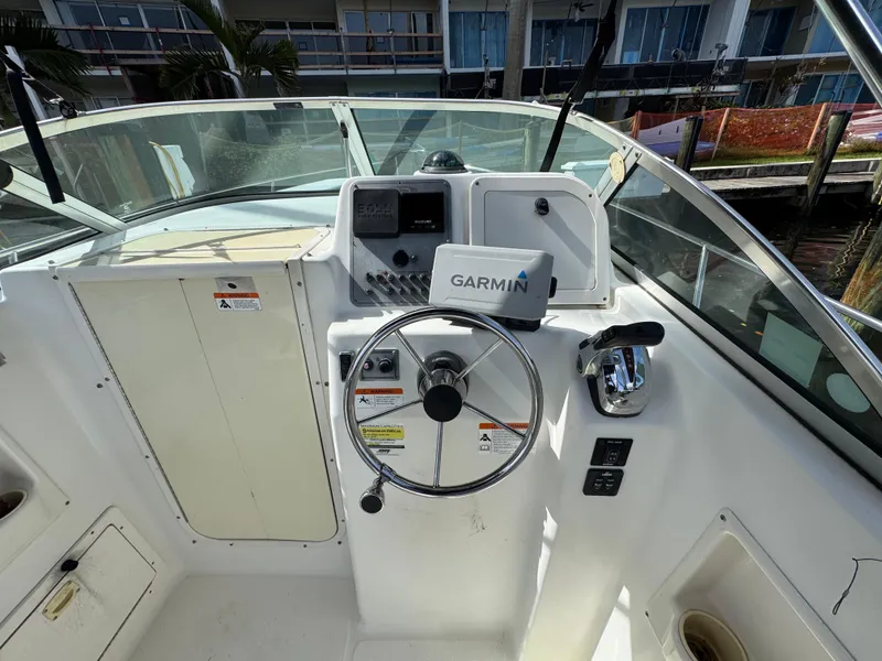Slide: The Image of 2005 Hydra-Sports Lightning 230 WA boat cockpit with Garmin navigation system and steering wheel. - 8