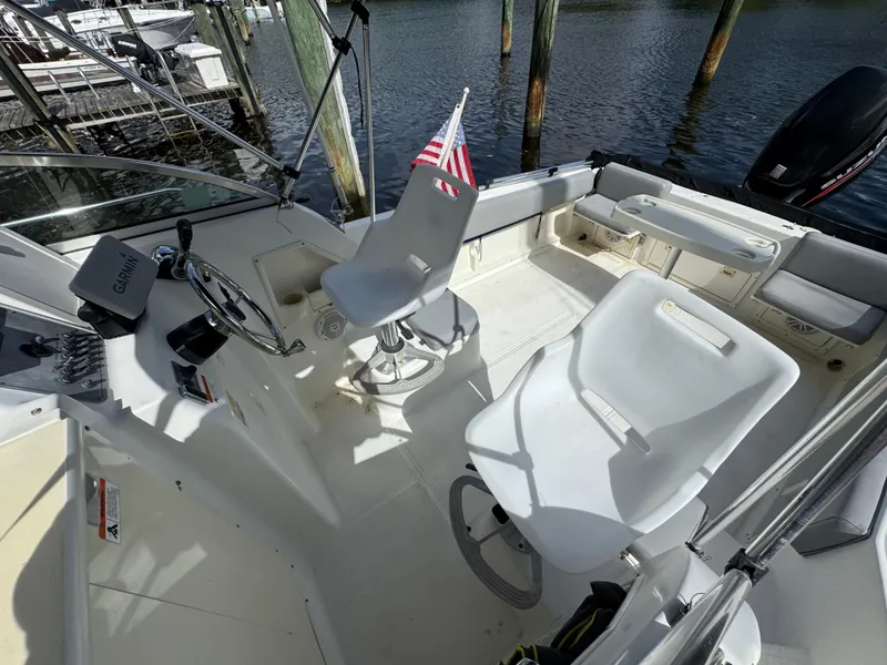 Slide: The Image of 2005 Hydra-Sports Lightning 230 WA boat interior with helm, seating, and American flag. - 9