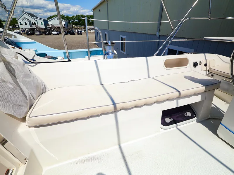Slide: The Image of Cockpit seating area of a 2001 Catalina 36 MkII sailboat, featuring cushioned bench and storage. - 12
