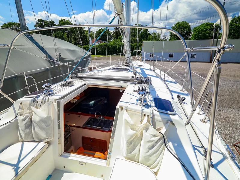 Slide: The Image of 2001 Catalina 36 MkII sailboat deck with open cabin, docked under sunny skies. - 17