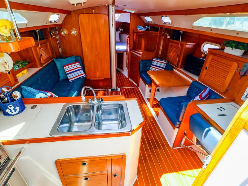 Slide: The Image of Interior of 2001 Catalina 36 MkII sailboat with wood finish and blue seating. - 18