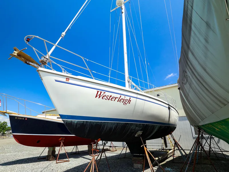 Slide: The Image of Catalina 36 MkII sailboat from 2001 named Westerleigh on dry dock under clear blue sky. - 2