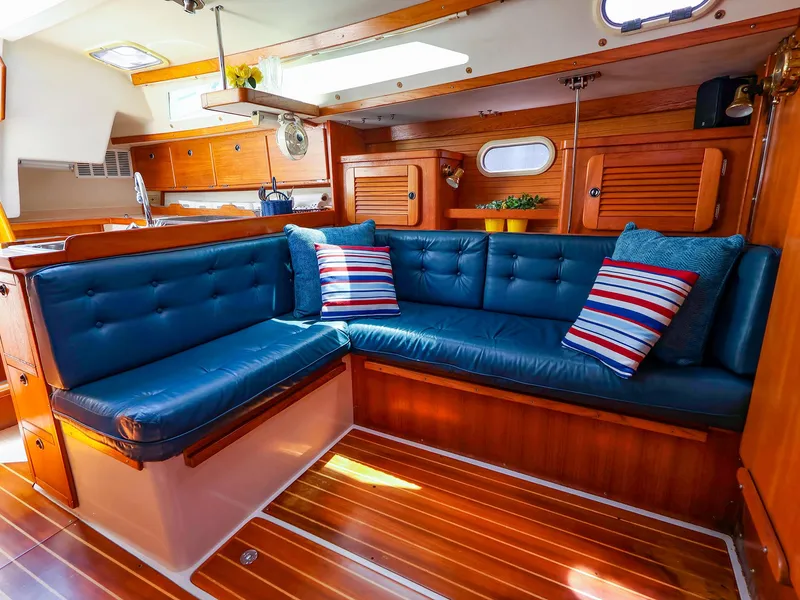 Slide: The Image of Interior of 2001 Catalina 36 MkII sailboat with blue seating and striped pillows. - 21